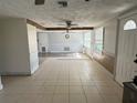 Spacious living room with tile floors and natural light from the windows at 2619 Albion St, Holiday, FL 34691