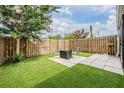 Private backyard with artificial grass, a wooden fence, and a cozy outdoor seating area, perfect for relaxing at 3029 Brookfield Ln, Clearwater, FL 33761