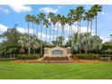 Plantation Palms Golf Club entrance featuring lush landscaping and decorative signage at 3137 Banyan Hill Ln, Land O Lakes, FL 34639