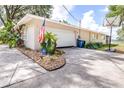 Spacious driveway leading to a two-car garage and features an American Flag at 35836 Lakeshore Dr, Dade City, FL 33525