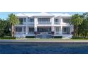 Luxury waterfront home with a stunning pool, waterfall feature, covered balconies, and lush landscaping at 38 Ladoga Ave, Tampa, FL 33606