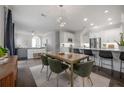 Open living space with modern chandelier, stainless steel appliances, and an open living concept at 403 S Fremont Ave # 3, Tampa, FL 33606