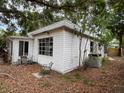 Back view of home showcasing siding, window and the partially fenced yard at 4050 Iris N St, St Petersburg, FL 33703