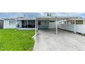 Exterior of a single story home with a carport and screened in patio at 4705 Murray Hill Dr, Tampa, FL 33615