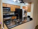 Well-equipped kitchen featuring a breakfast bar and stainless steel appliances at 500 Belcher S Rd # 109, Largo, FL 33771
