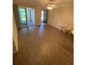 Bright living room with wood floors and sliding glass doors to the porch at 500 Belcher S Rd # 109, Largo, FL 33771