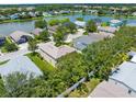 Aerial view of a residential community with a scenic lake and lush greenery at 5015 58Th E Ter, Bradenton, FL 34203