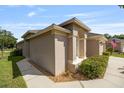 Attractive single-story home with a stucco exterior, arched entry, and well-kept landscaping at 5131 Gato Del Sol Cir, Wesley Chapel, FL 33544