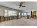 Bright living room with a ceiling fan, large window, and mirror, ready for renovation and personalization at 565 55Th Ne Ave, St Petersburg, FL 33703
