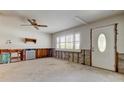 Living room with natural light from a large window, a ceiling fan and unfinished drywall at 565 55Th Ne Ave, St Petersburg, FL 33703
