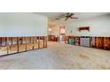 Spacious living room featuring a ceiling fan, and unfinished drywall, ready for your personal touch at 565 55Th Ne Ave, St Petersburg, FL 33703