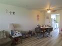 Inviting dining area with a ceiling fan, wood-look flooring, and a cozy table for Gathering meals at 5970 21St N St # 15, St Petersburg, FL 33714