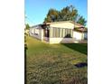 This property has a sunroom and a sprawling, green lawn area at 6443 Midland St, Zephyrhills, FL 33542