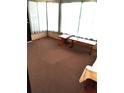 This sunny sunroom includes a bench and table seating area at 6443 Midland St, Zephyrhills, FL 33542