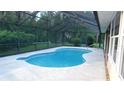 Enjoy outdoor living in this screened-in pool area, perfect for relaxation and entertainment at 6605 Foxmoor Dr, Zephyrhills, FL 33542