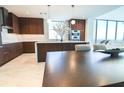Modern kitchen with wood cabinetry, an island, stainless appliances, and a view of the living area at 777 3Rd N Ave # 1503, St Petersburg, FL 33701