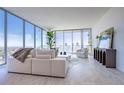 Bright living room with floor-to-ceiling windows showcasing city views and contemporary furnishings at 777 3Rd N Ave # 1503, St Petersburg, FL 33701