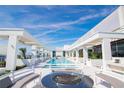 Rooftop pool area with modern white architecture, seating and open sky at 777 3Rd N Ave # 1703, St Petersburg, FL 33701