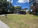 Charming single-story home with a well-maintained lawn and mature trees at 8018 Mulberry St, Tampa, FL 33604