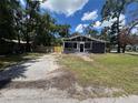 Charming single-story home with a well-maintained lawn and mature trees at 8018 Mulberry St, Tampa, FL 33604