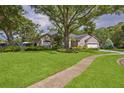 Charming single-story home with well-maintained lawn and mature trees at 803 Brooker Village Cir, Lutz, FL 33548