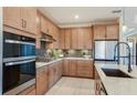 Bright kitchen with stainless steel appliances, tiled backsplash, and ample cabinet space at 10305 Cross River Trl, Parrish, FL 34219