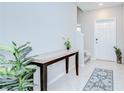 Entryway with tile flooring, console table, and a white front door at 10360 Blue Plume Ct, Riverview, FL 33578