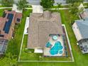 Aerial view of a home with a screened-in pool and well-maintained landscaping at 10532 Plantation Bay Dr, Tampa, FL 33647