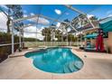 Screened-in pool and spa, perfect for relaxation and entertainment with a white fence and lake view at 10532 Plantation Bay Dr, Tampa, FL 33647