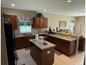 Spacious kitchen features granite countertops, dark wood cabinets, and stainless steel appliances at 12231 Fairlawn Dr, Riverview, FL 33579