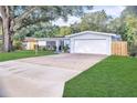 A well-maintained single-story home with an attached garage and beautiful landscaping at 1384 S Hillcrest Ave, Clearwater, FL 33756