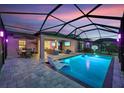 Screened-in pool area with outdoor kitchen, dining, and lounge spaces at 14514 Woodland Spur Dr, Lithia, FL 33547
