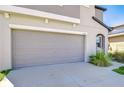 Spacious two-car garage featuring an automatic door and convenient driveway access at 15505 Wicked Strong St, Sun City Center, FL 33573