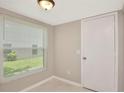 Cozy room with a large window, neutral walls, white door, and tile flooring that can serve as a study or office at 1621 Crossridge Dr, Brandon, FL 33510