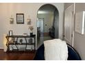 Stylish entryway featuring hardwood floors, decorative shelves, and an arched doorway at 1941 Greenwood Valley Dr, Plant City, FL 33563