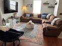 Cozy living room with a large sectional sofa, decorative rug, and bright natural light at 1941 Greenwood Valley Dr, Plant City, FL 33563