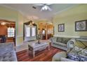 Spacious living room with hardwood floors, elegant furnishings, and an open layout at 2535 Regal River Rd, Valrico, FL 33596