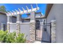 Charming gated front entrance with stone accents and lush greenery, offering privacy and curb appeal at 288 Villa Corte Dr, Lutz, FL 33549