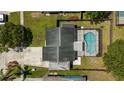 Aerial view of a fenced property featuring a screened-in swimming pool and patio area at 3133 Payne St, New Port Richey, FL 34655