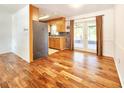 Inviting living room boasts gleaming hardwood floors, modern lighting, and seamless access to the kitchen at 3304 Alamar St, Lutz, FL 33558