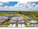 Stunning aerial view of a townhome community with golf course, pool, and serene lake views at 43250 Water Bird Way # 5921, Punta Gorda, FL 33982