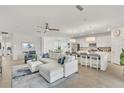 Bright, open-concept living room and kitchen boasts a large island with barstool seating at 43250 Water Bird Way # 5921, Punta Gorda, FL 33982