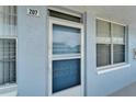 Apartment 207's front door, reflecting the building's exterior and design details at 4895 Bay Ne St # 207, St Petersburg, FL 33703