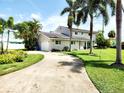 Front exterior view of the home with a circular driveway and beautiful landscaping at 5101 Dover Ne St, St Petersburg, FL 33703