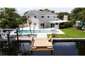 Back exterior view of house highlighting the pool, dock, and waterfront at 5101 Dover Ne St, St Petersburg, FL 33703