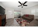 Bright living room with wood-look tile, fireplace, and comfortable seating arrangement at 520 34Th N Ave, St Petersburg, FL 33704