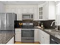 Updated kitchen with stainless steel appliances, granite countertops, and stylish cabinetry at 529 59Th S Way, St Petersburg, FL 33707