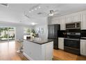 Modern kitchen with stainless steel appliances, granite countertops, and a breakfast bar at 529 59Th S Way, St Petersburg, FL 33707
