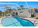 Screened-in pool area featuring a sparkling blue pool, surrounded by a concrete deck at 529 59Th S Way, St Petersburg, FL 33707