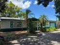 A quaint, single-story home showcasing a modest front yard and traditional design elements at 5630 47Th N Ave, Kenneth City, FL 33709